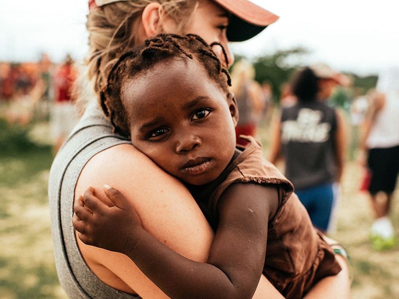 An adult holding a young child